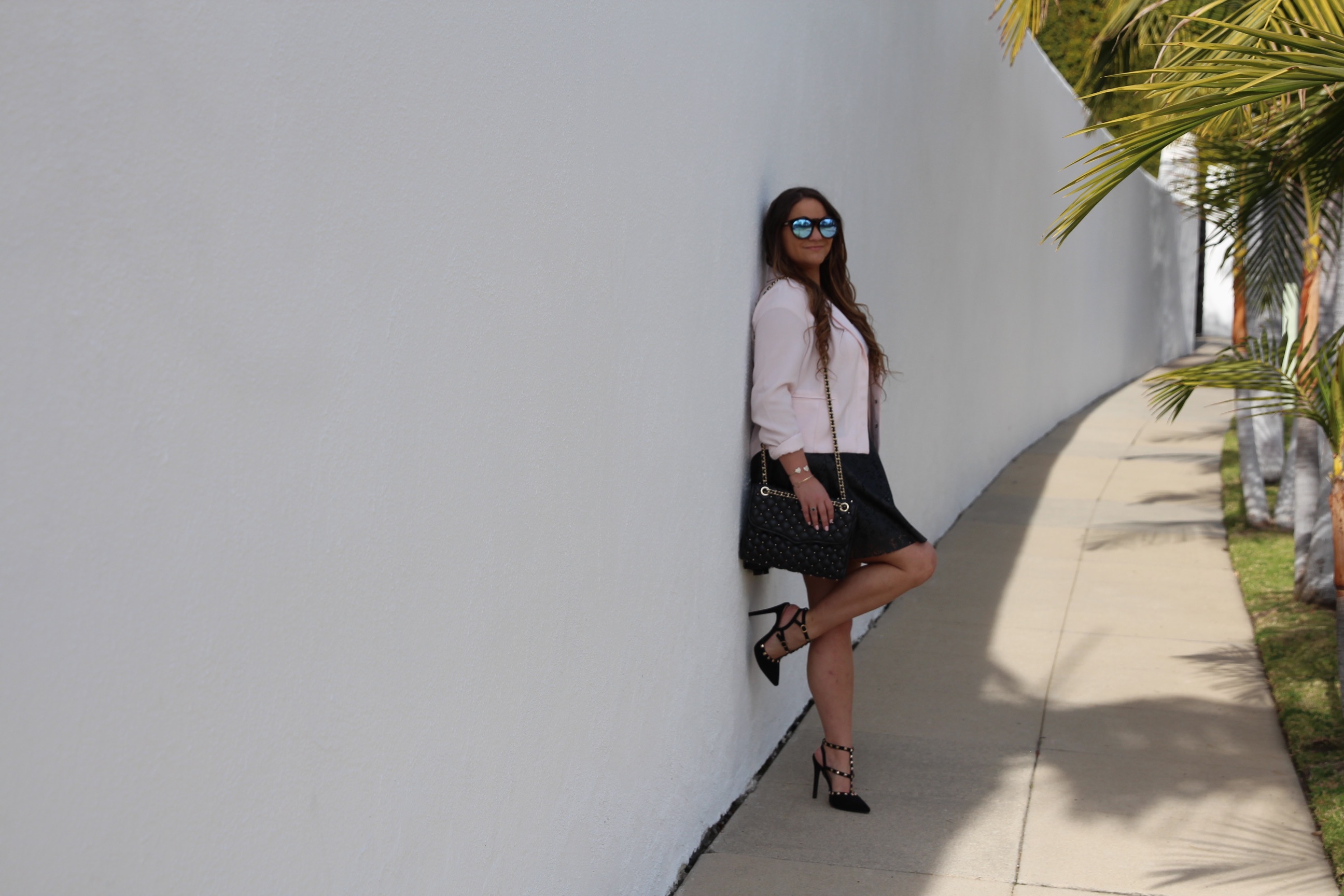 missyonmadison, fashion blog, fashion blogger, perforated skirt, black leather skirt, white crop top, white short sleeve crop top, light pink moto jacket, black studded heels, rockstud heels, look for less, le specs sunglasses, mirrored sunglasses, brunette hair, summer style, how to style a moto jacket, how to wear a leather skirt, la blogger, la style, melissa tierney,